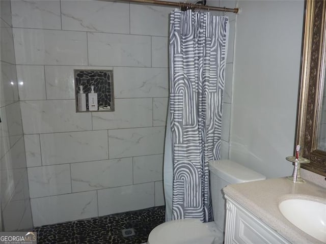 bathroom with vanity, toilet, and walk in shower