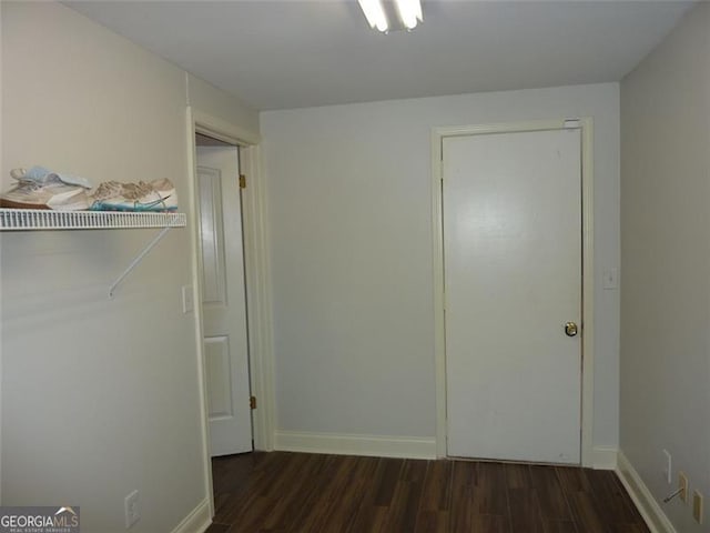 unfurnished bedroom with dark hardwood / wood-style floors