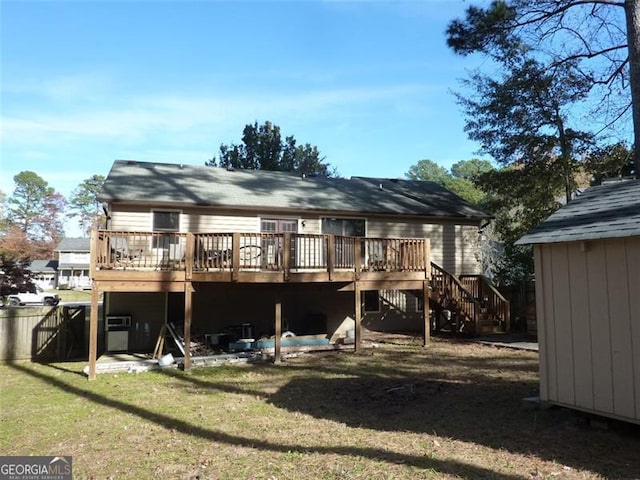 rear view of property featuring a shed, a lawn, and a deck