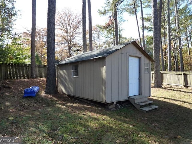 view of outbuilding featuring a lawn