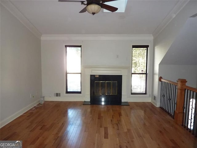 unfurnished living room with ceiling fan, ornamental molding, and hardwood / wood-style floors