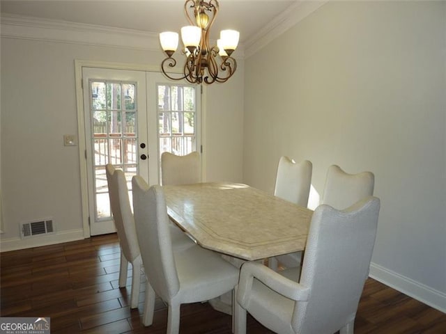 dining area featuring ornamental molding, a chandelier, dark hardwood / wood-style flooring, and french doors