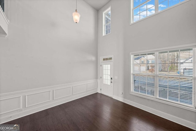 foyer entrance with dark hardwood / wood-style floors