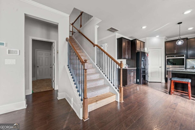 stairway featuring hardwood / wood-style flooring and crown molding