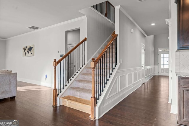 staircase with hardwood / wood-style flooring and crown molding