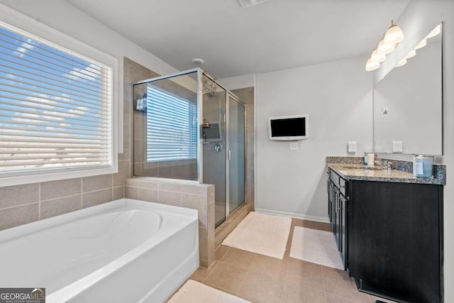 bathroom featuring tile patterned floors, shower with separate bathtub, and vanity