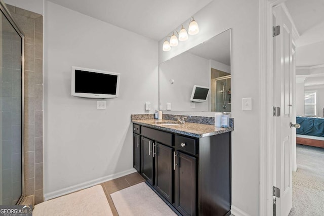 bathroom featuring vanity and a shower with shower door