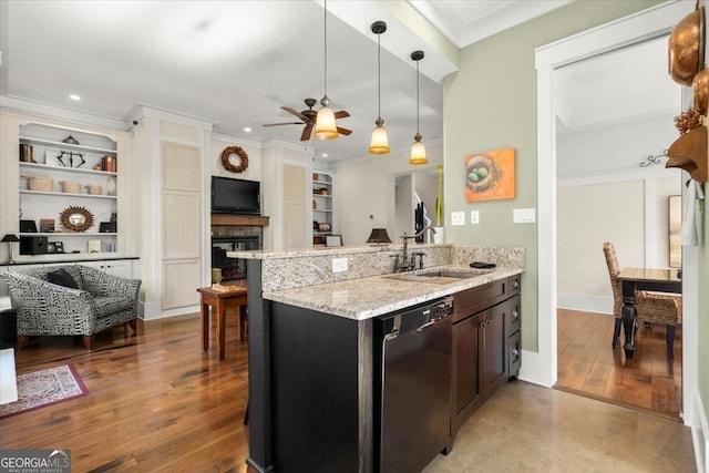 kitchen featuring hanging light fixtures, black dishwasher, sink, and kitchen peninsula