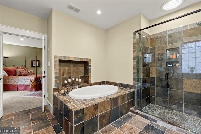 bathroom featuring shower with separate bathtub