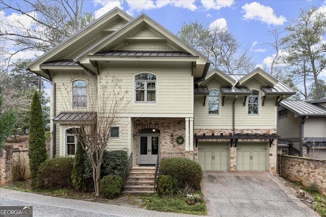 view of front of home with a garage and french doors