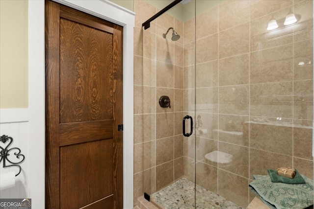 bathroom featuring a shower with door