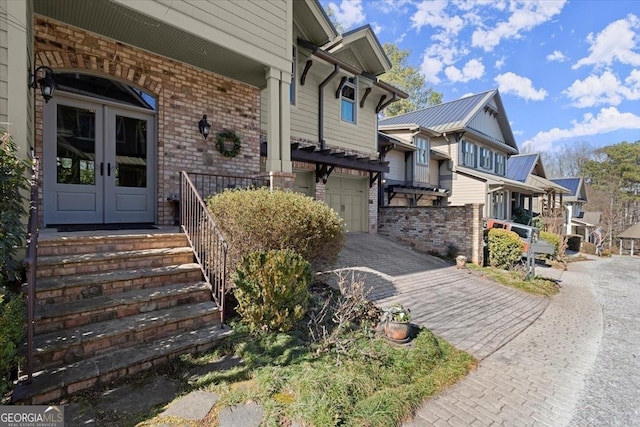 exterior space with french doors and a garage