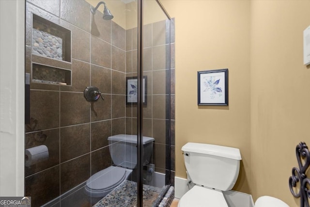 bathroom featuring walk in shower and toilet