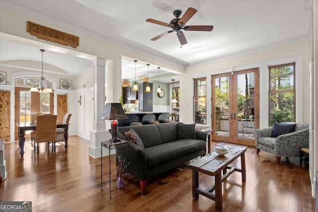 living room with french doors, crown molding, ceiling fan with notable chandelier, and hardwood / wood-style floors