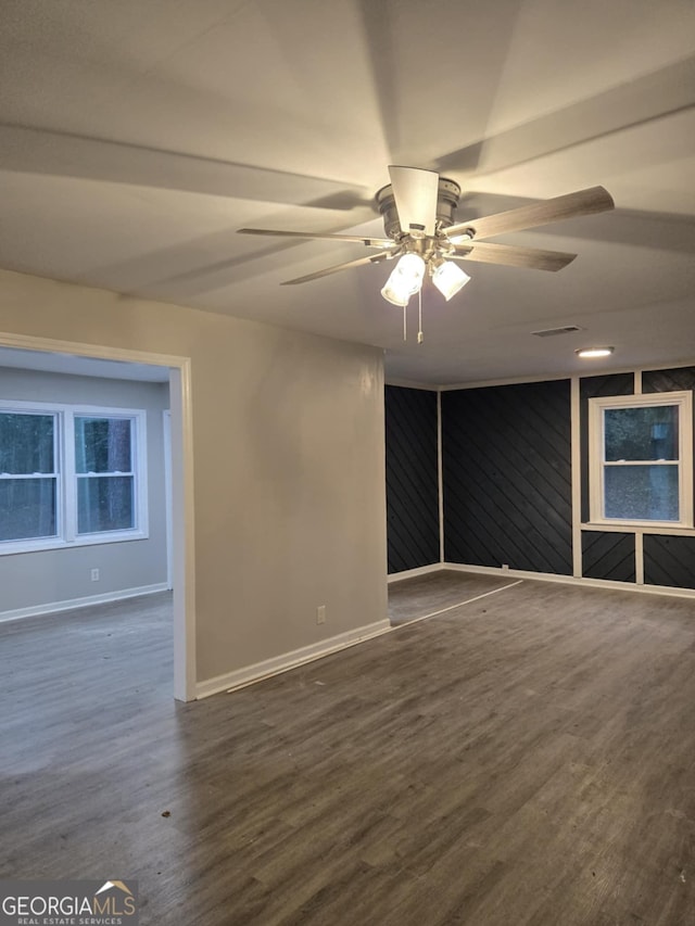 spare room featuring dark wood-type flooring and ceiling fan