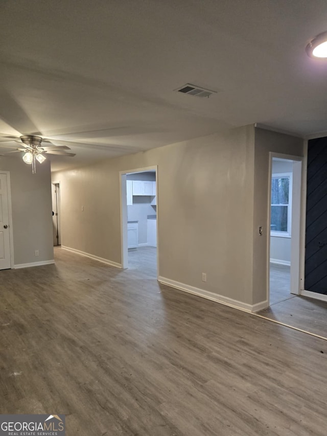 spare room with hardwood / wood-style floors and ceiling fan