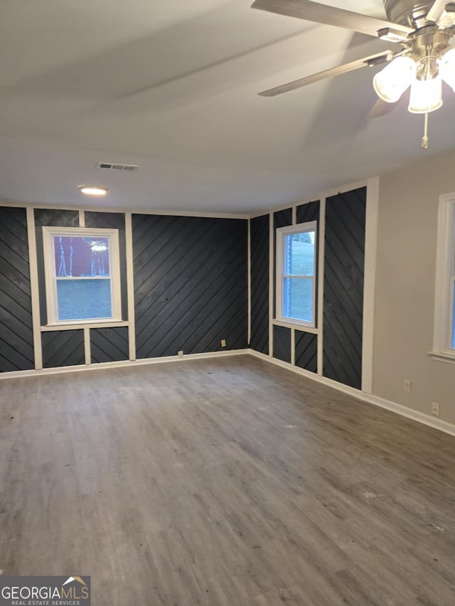 empty room with hardwood / wood-style flooring and ceiling fan