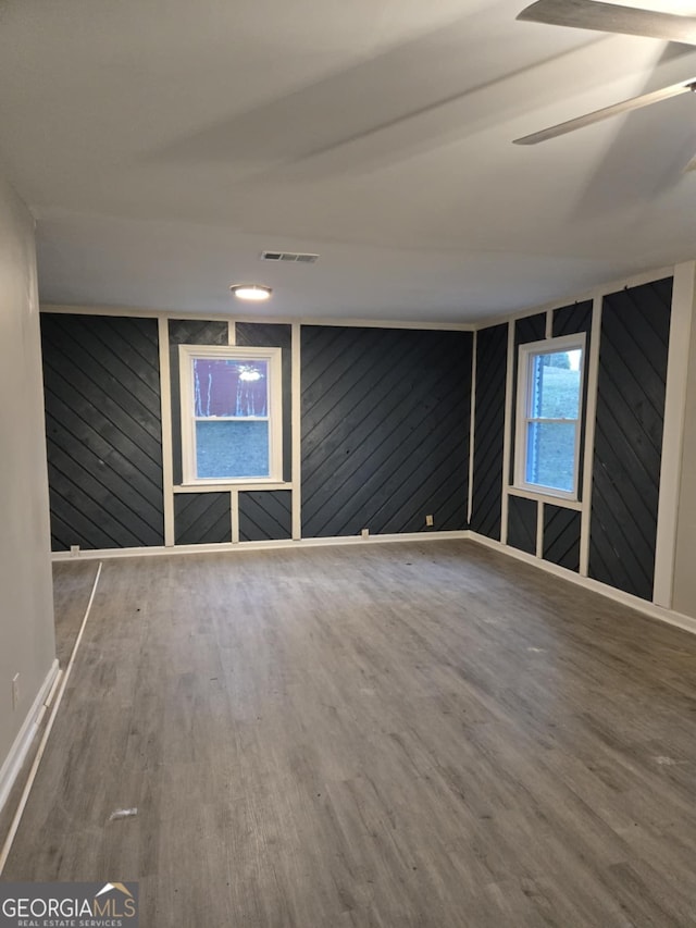 empty room with wood-type flooring and ceiling fan