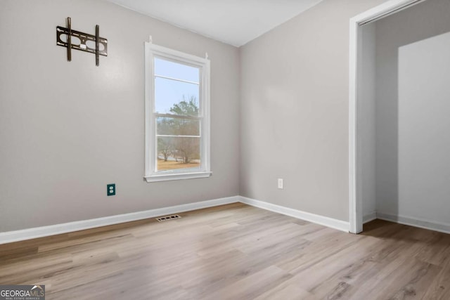 spare room featuring light hardwood / wood-style flooring