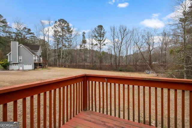 wooden terrace featuring a lawn