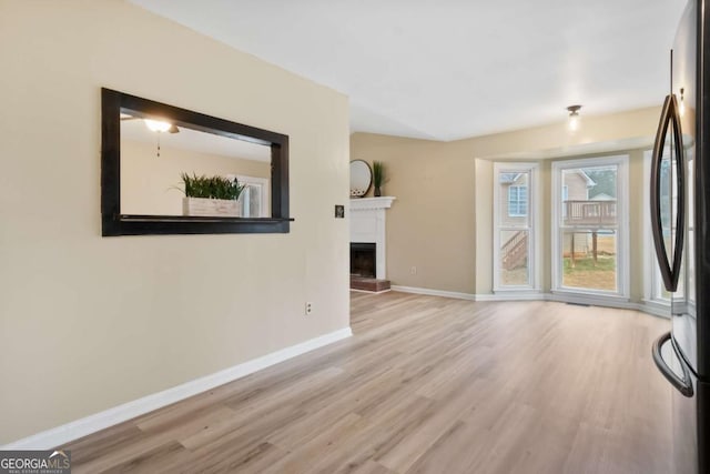 unfurnished living room with light hardwood / wood-style flooring