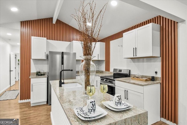 kitchen featuring white cabinetry, light stone counters, and appliances with stainless steel finishes