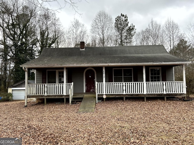 farmhouse with an outbuilding and a garage