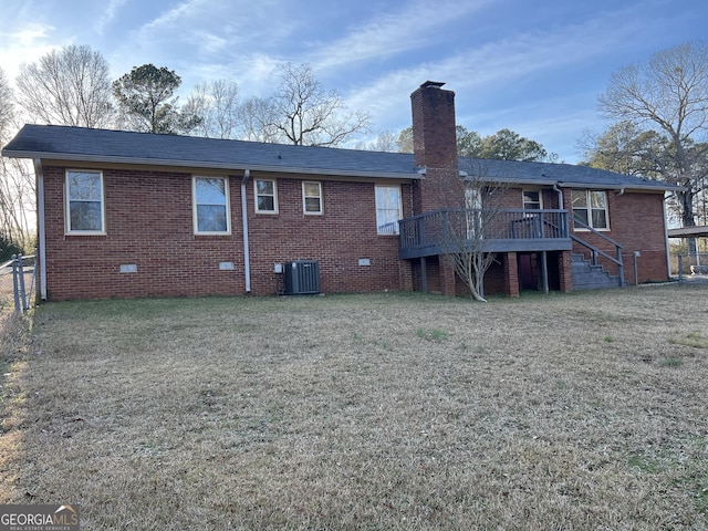 back of property featuring central AC, a wooden deck, and a lawn