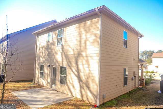 view of side of home featuring a patio area