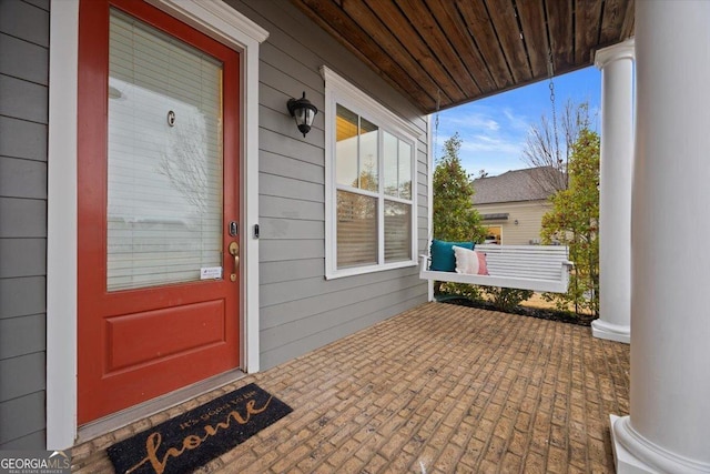 view of exterior entry with covered porch