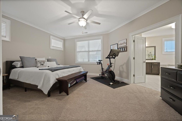 bedroom featuring multiple windows, crown molding, light carpet, and ensuite bathroom