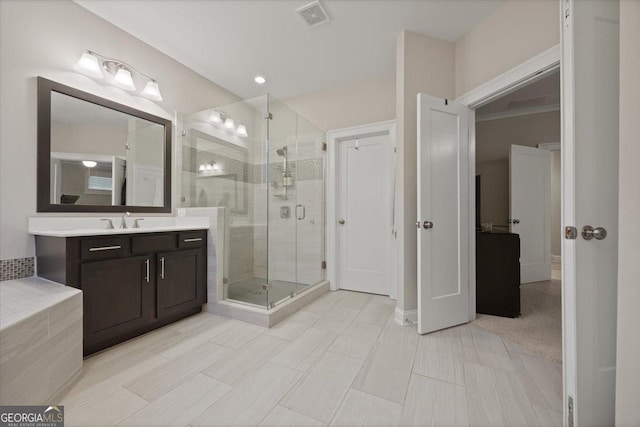 bathroom with vanity and a shower with door