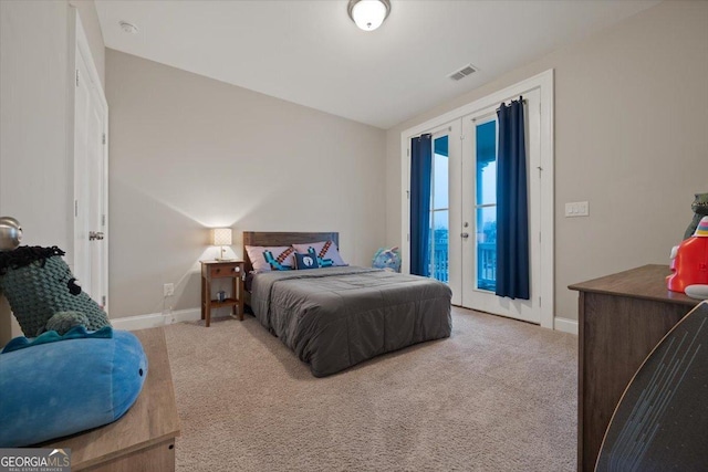 carpeted bedroom featuring french doors and access to exterior