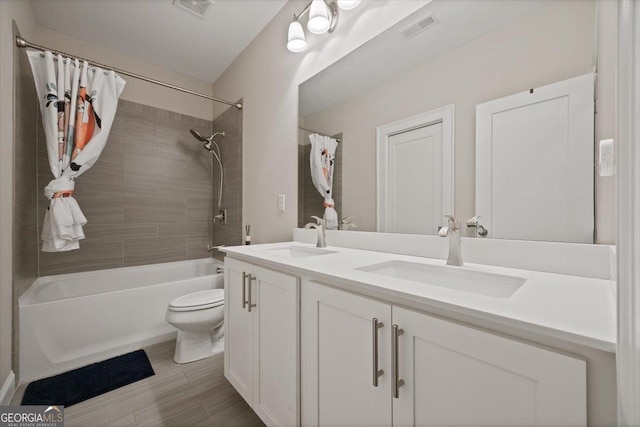 full bathroom featuring shower / tub combo with curtain, vanity, and toilet