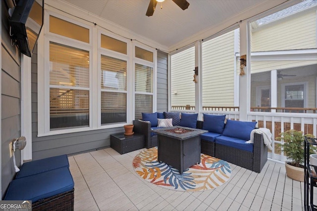 wooden deck with ceiling fan and an outdoor living space with a fire pit