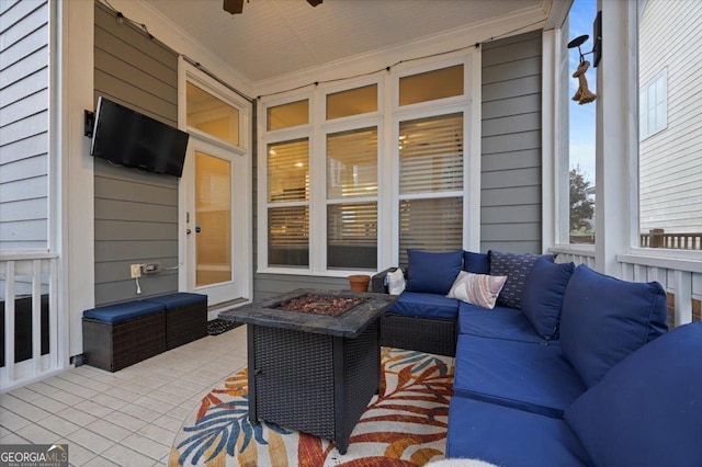 view of patio / terrace featuring ceiling fan and an outdoor living space with a fire pit