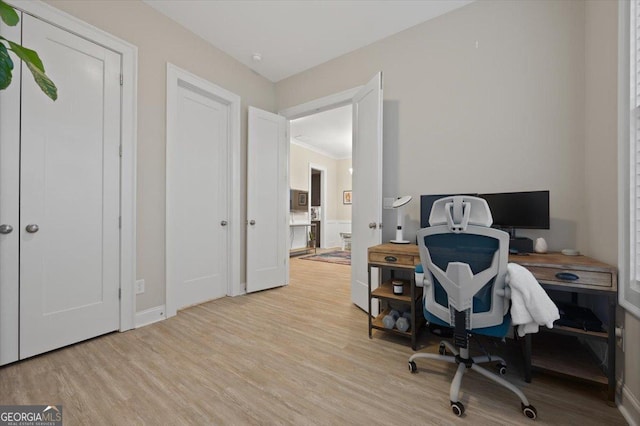 home office with light hardwood / wood-style floors