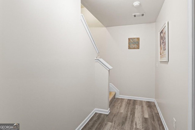 stairway featuring hardwood / wood-style floors