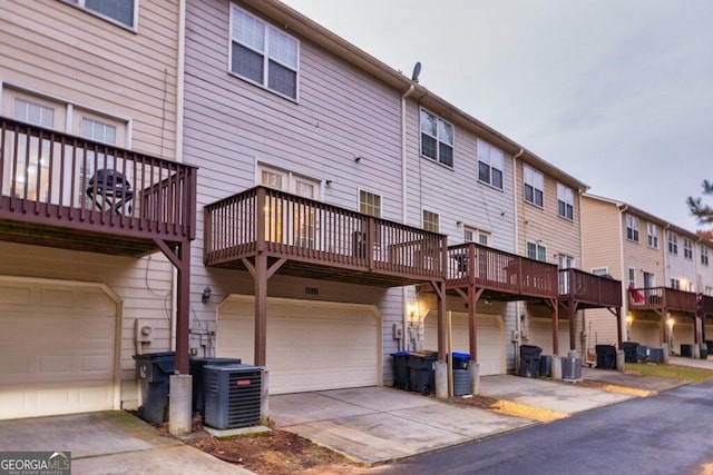 exterior space featuring a wooden deck, a garage, and central air condition unit