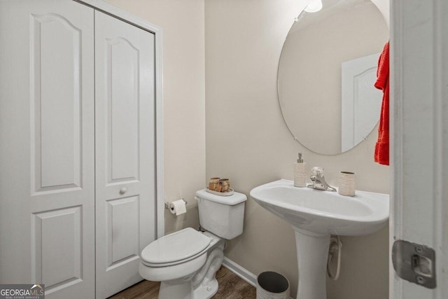 bathroom featuring sink, wood-type flooring, and toilet