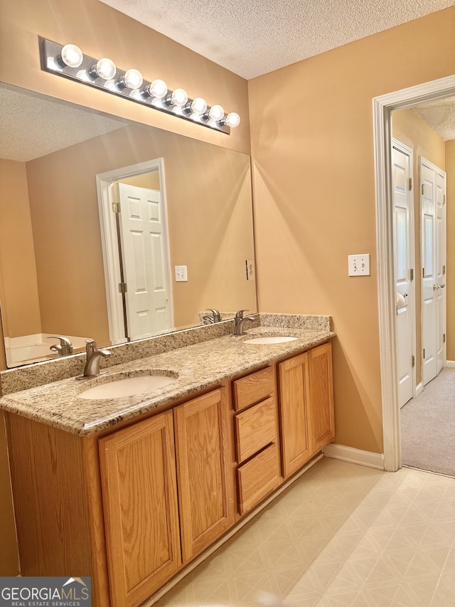 bathroom with vanity and a textured ceiling