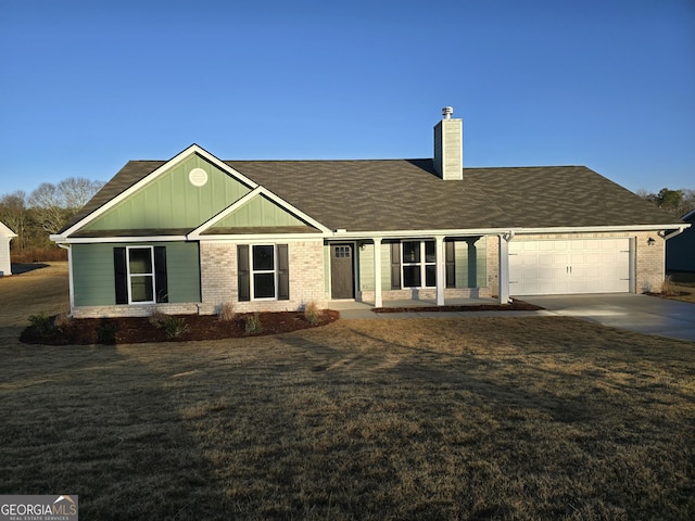 view of front of home featuring a garage and a front lawn