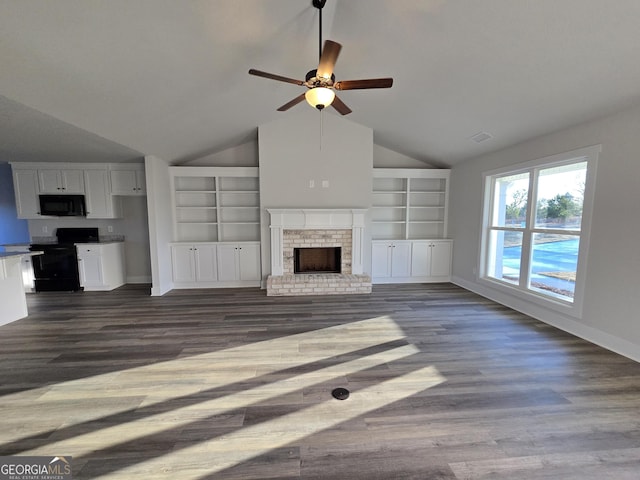 unfurnished living room with vaulted ceiling, dark wood-type flooring, a fireplace, and built in shelves