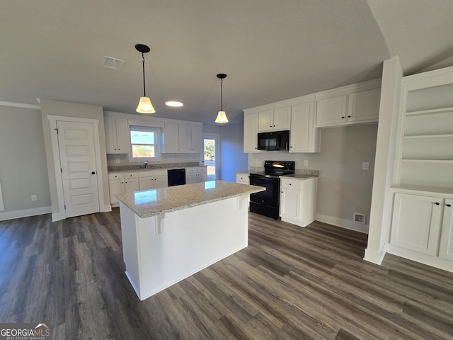 kitchen featuring white cabinetry, pendant lighting, a center island, and black appliances