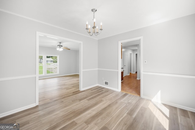 empty room with ornamental molding, ceiling fan with notable chandelier, and light wood-type flooring