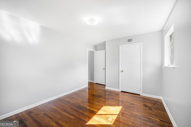 spare room with dark wood-type flooring