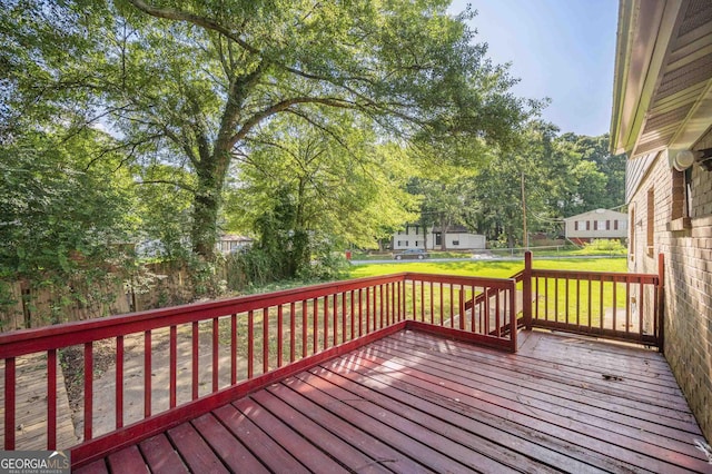 wooden deck featuring a yard