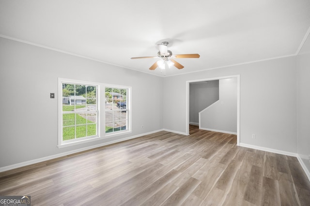 spare room featuring ornamental molding, ceiling fan, and light wood-type flooring