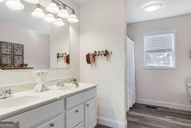 bathroom featuring hardwood / wood-style flooring, vanity, and toilet