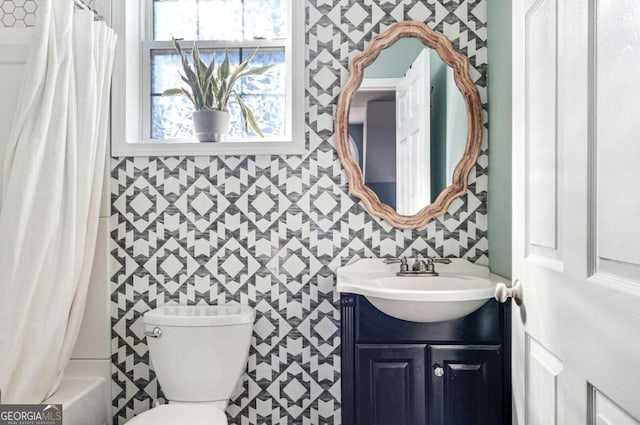 full bathroom featuring vanity, tile walls, toilet, and shower / bath combo with shower curtain